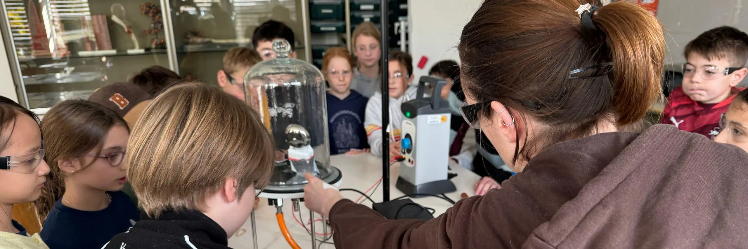 ISD science teacher running a demonstration in an elementary school lesson.