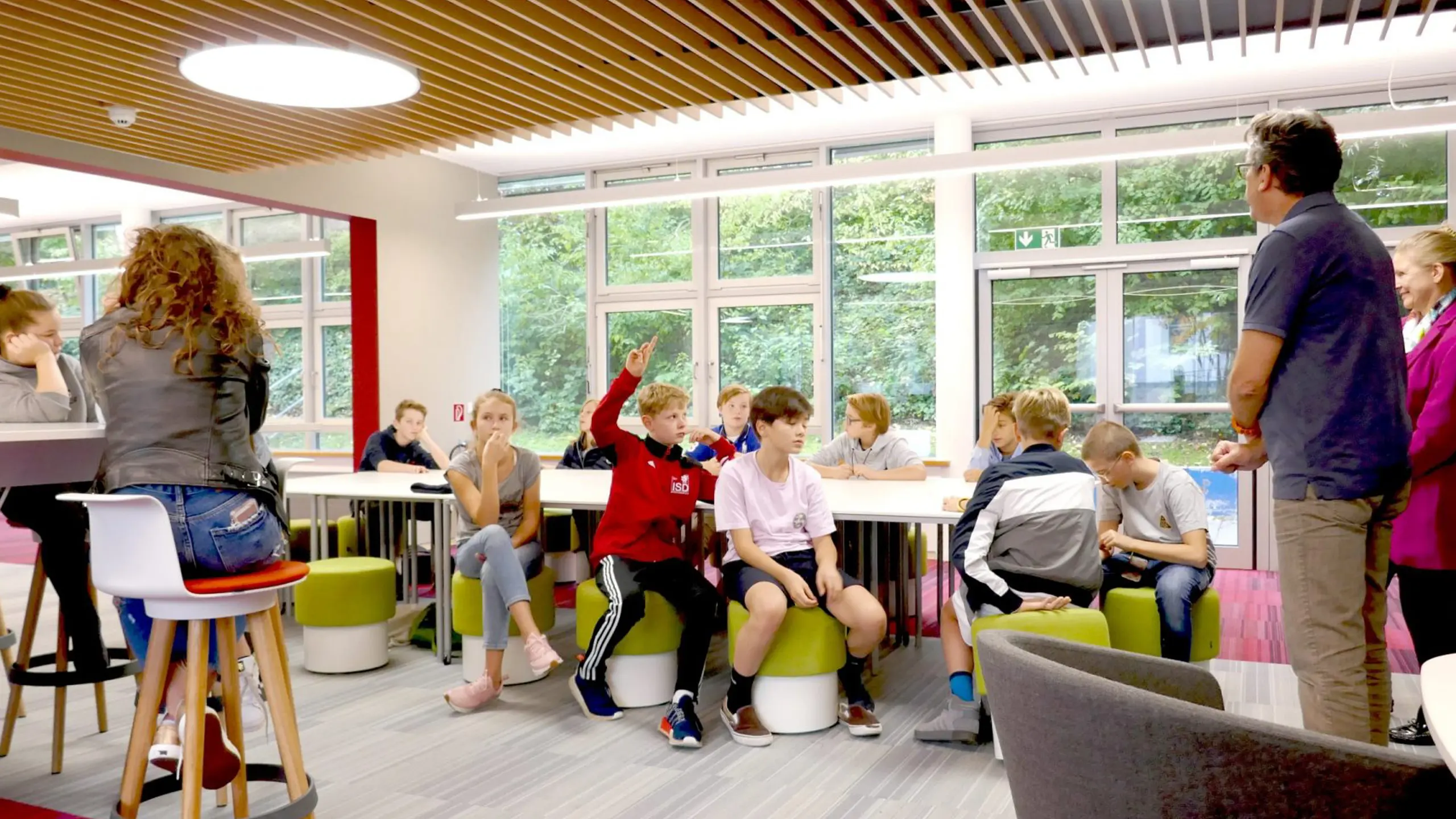 Students in a modern classroom learning from a teacher,