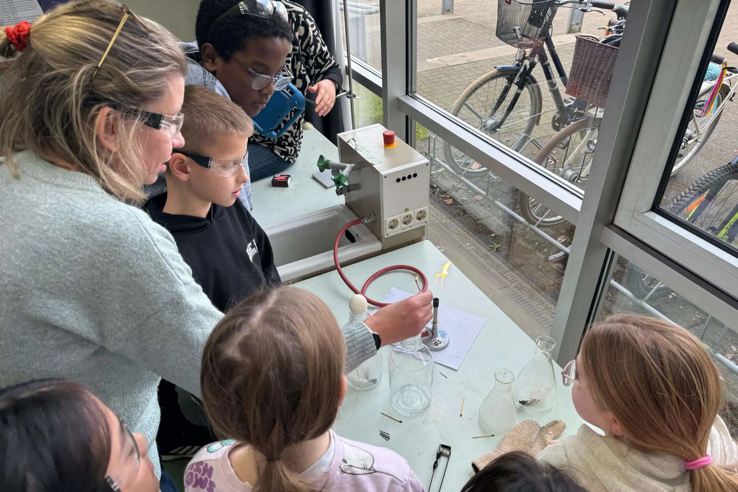 ISD Teacher and Elementary School pupils conducting an experiment in a Science lesson.