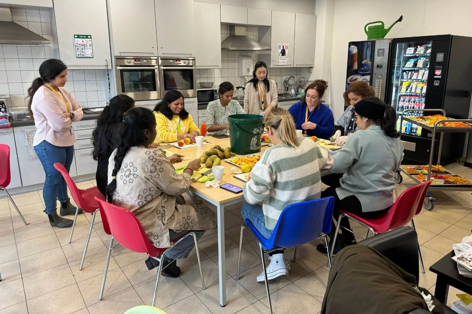 ISD Parent volunteers chopping fruit for the Welcome Back Picnic.