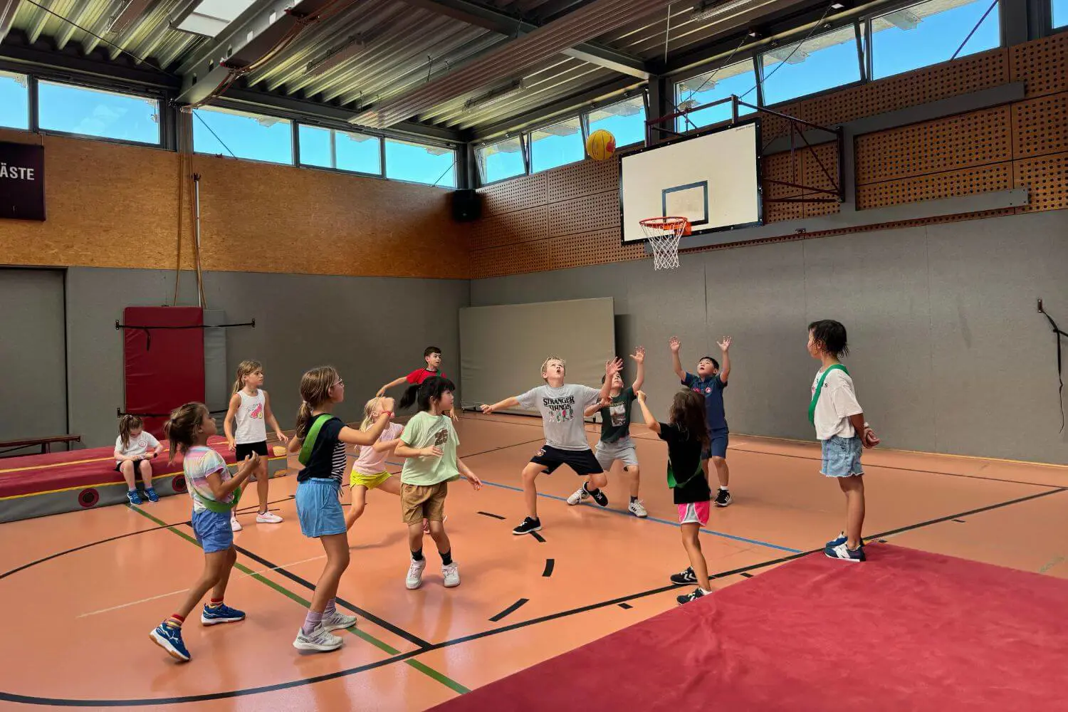 A group of young ISD students playing basketball.