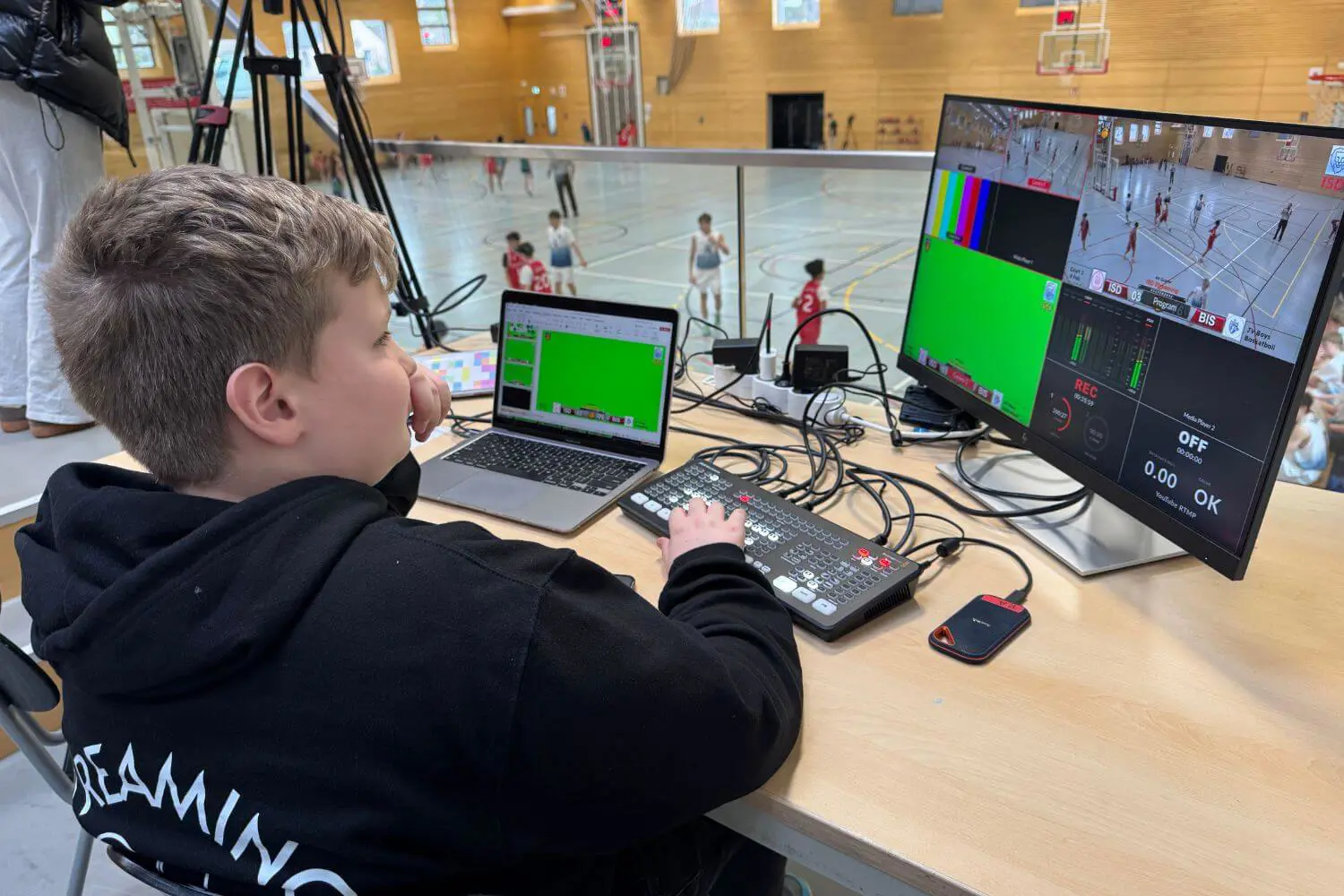 ISD pupils filming and broadcasting a sports match.