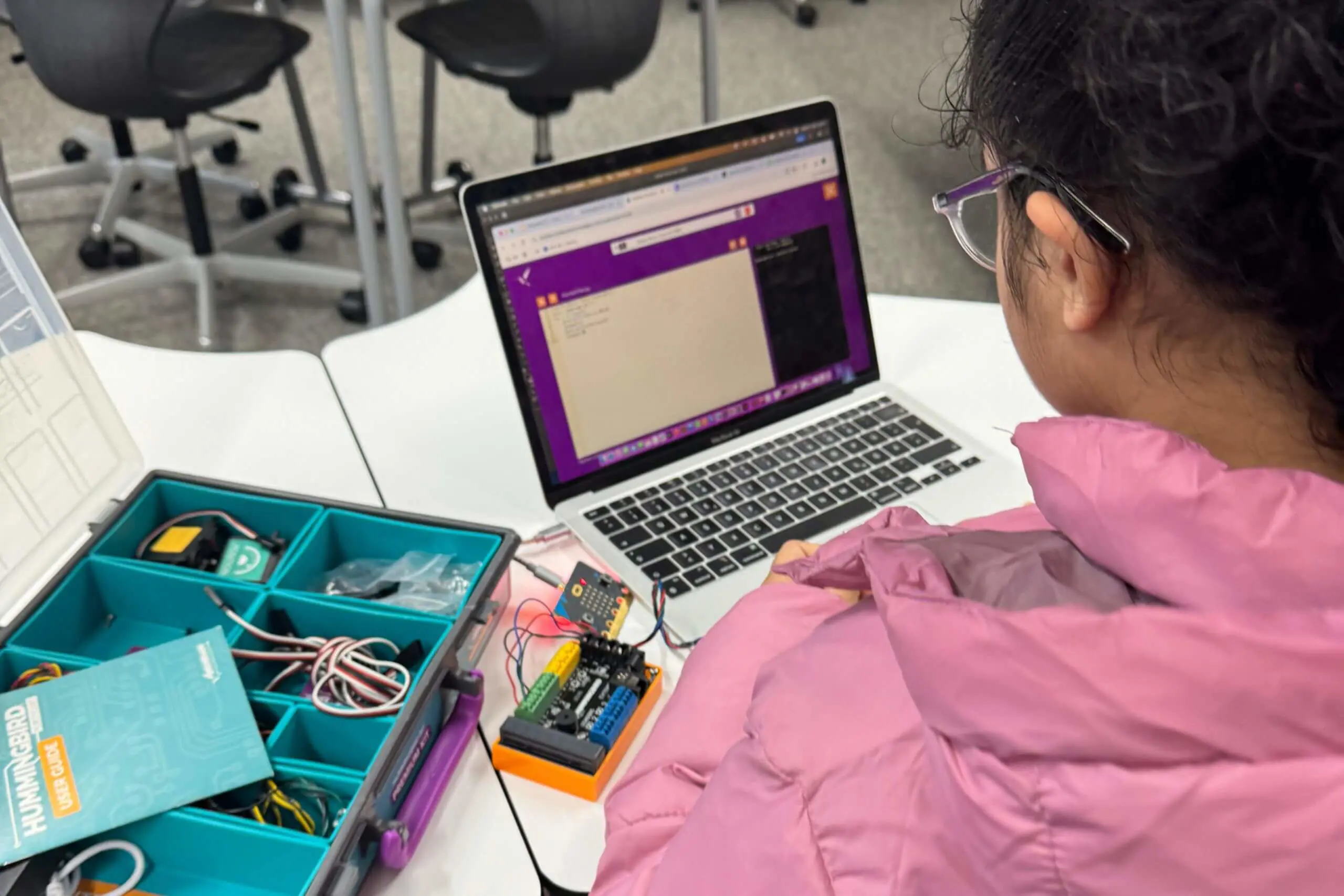 ISD pupils coding with a laptop.