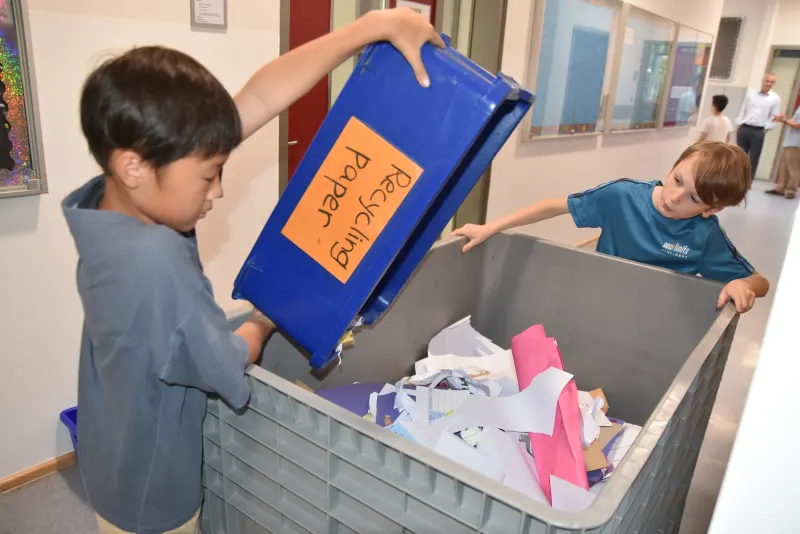 Young ISD Students sorting trash bin for recycled papers