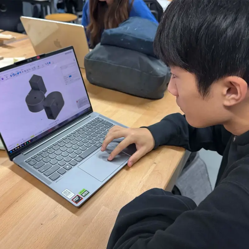 ISD senior student working on a project with a laptop.